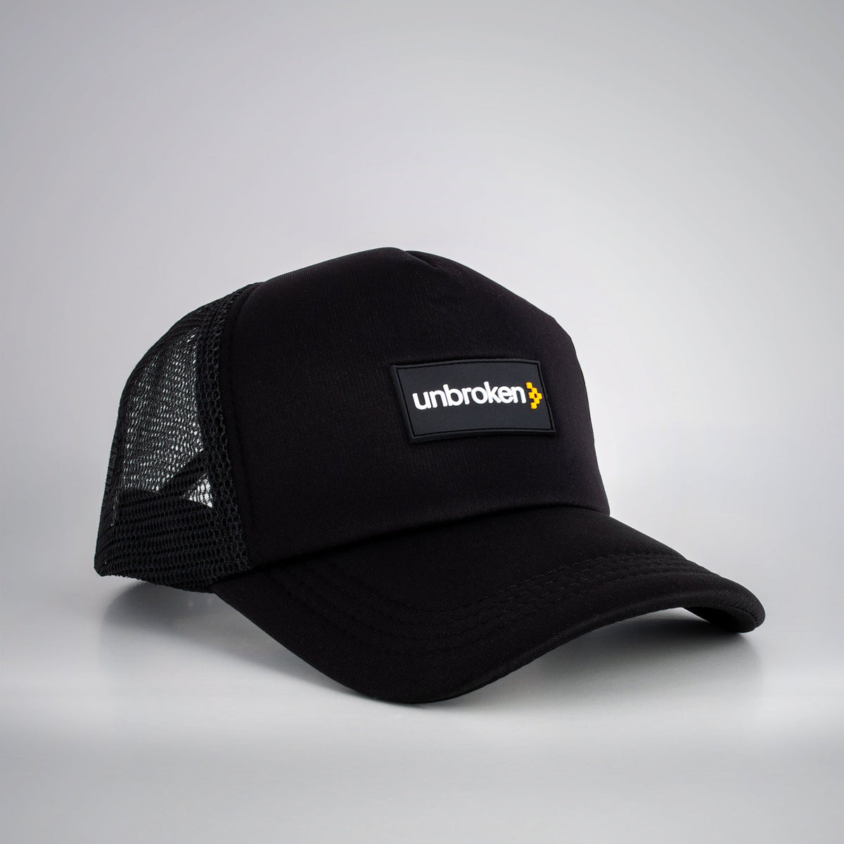 Black Unbroken trucker hat with the Unbroken logo patch